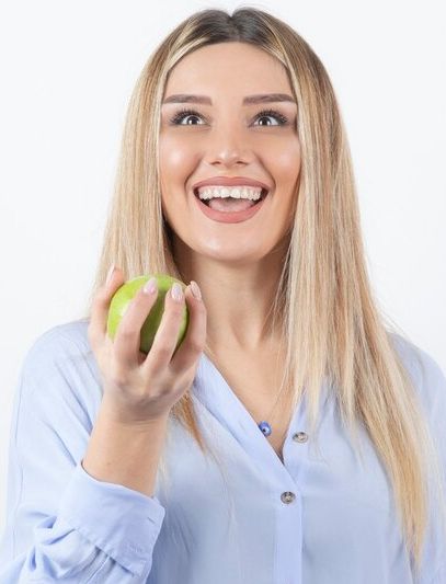 Smiling adult woman with clear aligners at Classic City Orthodontics